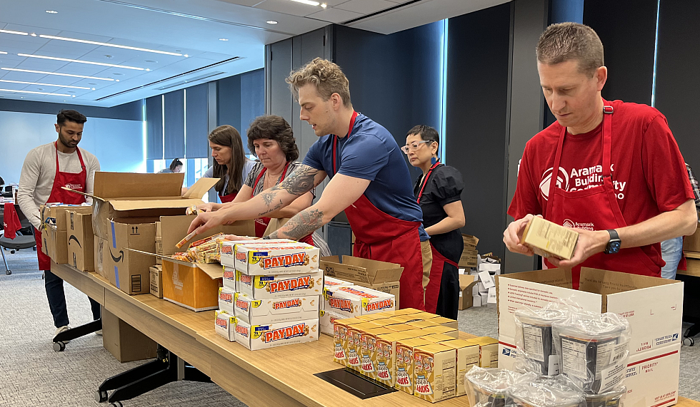 Aramark volunteers packing boxes